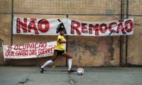 Action from the People's Cup in Rio de Janeiro. The banners read 'No to evictions' and 'Second occupation, Quilombo of the Warriors'. A quilombo refers to a community of runaway slaves. Photo: Pilar Olivares/Reuters